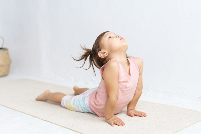 A kid practicing yoga.