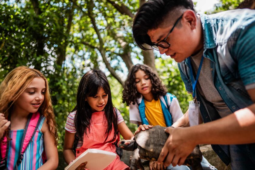 Kids holding a turtle.