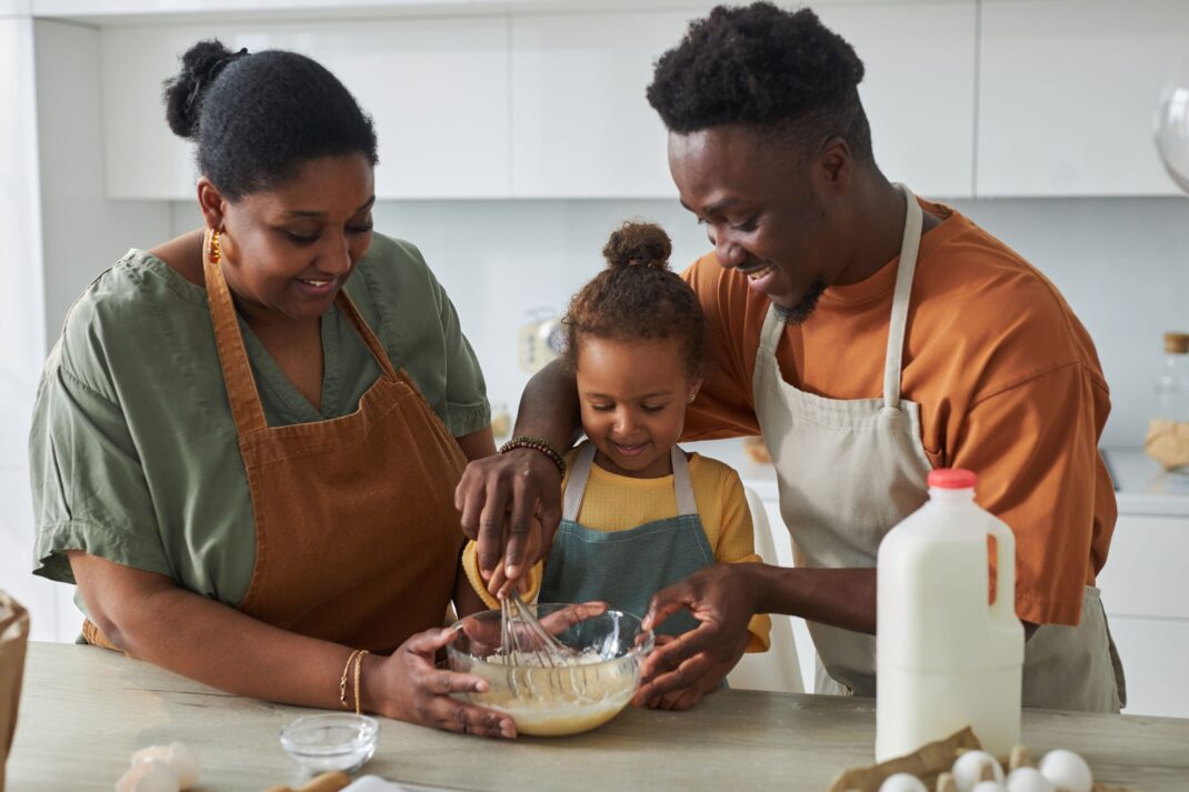 toddler cooking with parents