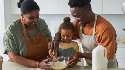toddler cooking with parents